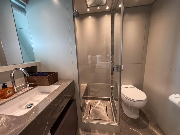  Yacht Photos Pics Luxurious bathroom in 2023 Sanlorenzo SX88 yacht with marble countertop and glass shower.