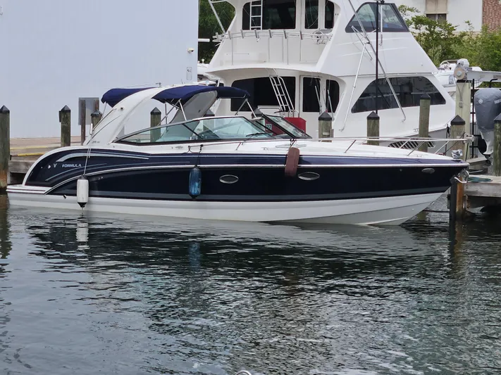  Yacht Photos Pics 2018 Formula 350 Sun Sport boat docked in marina, sleek design, blue and white exterior.