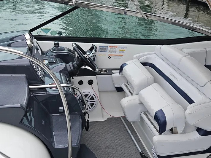  Yacht Photos Pics 2018 Formula 350 Sun Sport boat interior with steering wheel and seating.