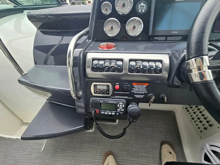  Yacht Photos Pics Control panel of a 2018 Formula 350 Sun Sport boat with gauges and radio equipment.