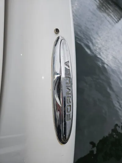  Yacht Photos Pics Close-up of 2018 Formula 350 Sun Sport boat emblem near water.