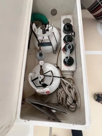 Emily Anne Yacht Photos Pics 2001 Island Gypsy Euro Sedan Trawler storage compartment with propane tanks and ropes.