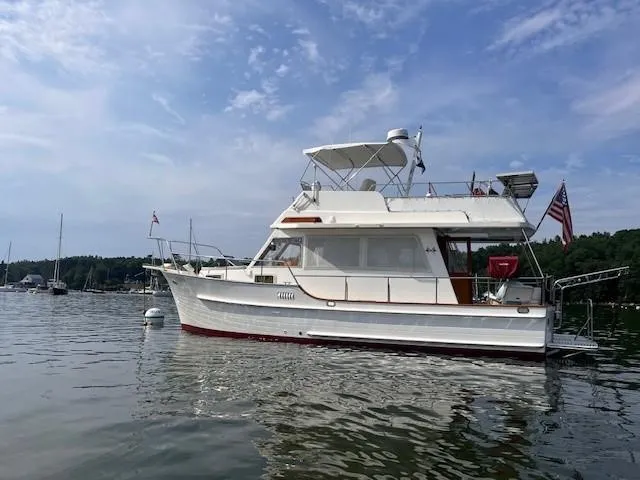 Emily Anne Yacht Photos Pics 2001 Island Gypsy Euro Sedan Trawler on calm water, under a partly cloudy sky.