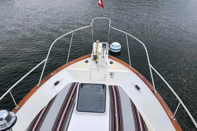 Emily Anne Yacht Photos Pics Bow view of 2001 Island Gypsy Euro Sedan Trawler on calm water.