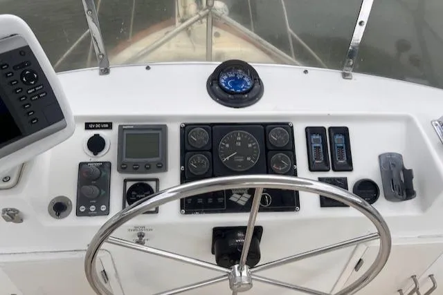 Emily Anne Yacht Photos Pics 2001 Island Gypsy Euro Sedan Trawler helm with navigation instruments and steering wheel.