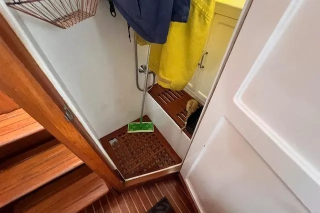 Emily Anne Yacht Photos Pics 2001 Island Gypsy Euro Sedan Trawler interior with wooden flooring and hanging raincoats.