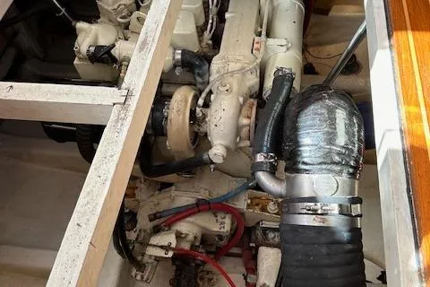 Emily Anne Yacht Photos Pics Engine compartment of 2001 Island Gypsy Euro Sedan Trawler, showcasing mechanical components and hoses.