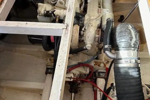 Emily Anne Yacht Photos Pics Engine compartment of 2001 Island Gypsy Euro Sedan Trawler, showcasing mechanical components and hoses.