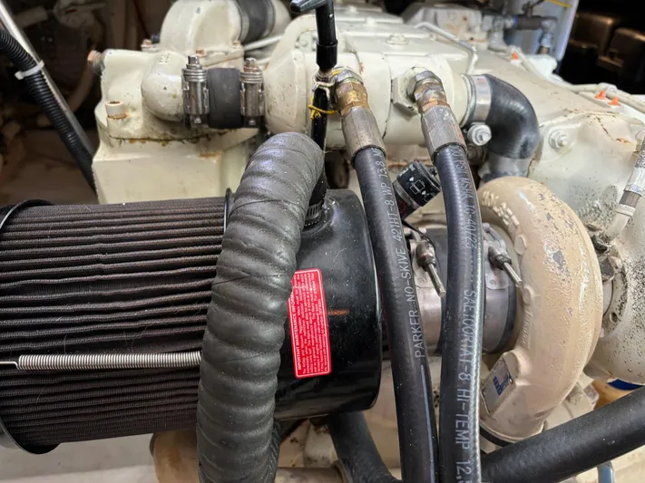 Emily Anne Yacht Photos Pics Engine components of a 2001 Island Gypsy Euro Sedan Trawler, featuring hoses and filters.