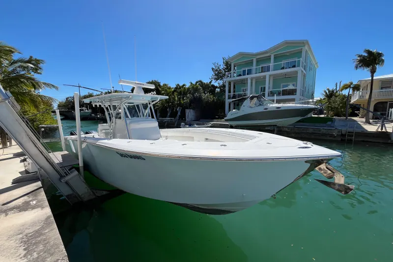  Yacht Photos Pics 2016 SeaHunter 35 Tournament boat docked near waterfront homes, under clear blue sky.
