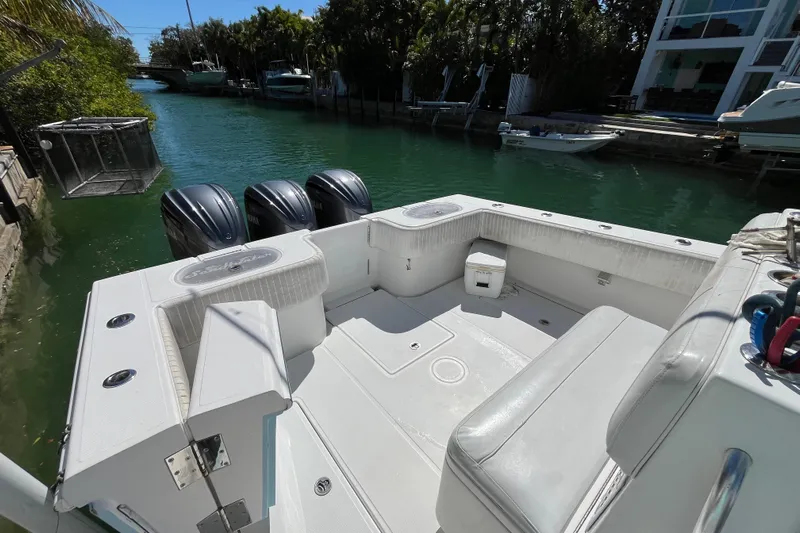  Yacht Photos Pics 2016 SeaHunter 35 Tournament boat with triple engines docked in a serene canal setting.