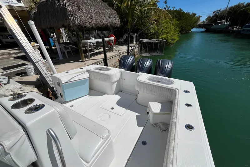  Yacht Photos Pics 2016 SeaHunter 35 Tournament boat docked by a canal, featuring triple outboard engines.