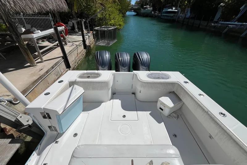  Yacht Photos Pics 2016 SeaHunter 35 Tournament boat with triple engines docked in a serene canal.