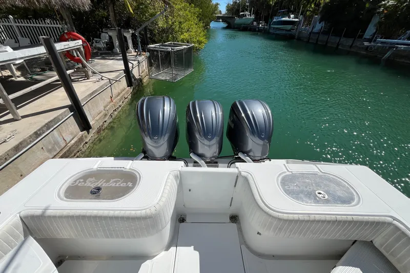  Yacht Photos Pics 2016 SeaHunter 35 Tournament boat with triple outboard engines docked in a canal.