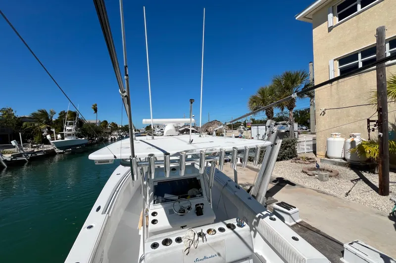  Yacht Photos Pics 2016 SeaHunter 35 Tournament boat docked by a canal under clear blue skies.