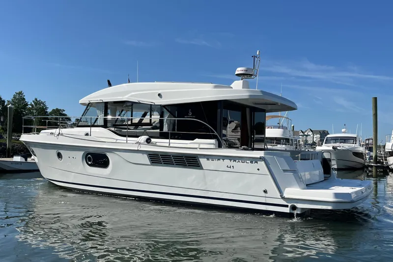  Yacht Photos Pics 2026 Beneteau 41 Swift Trawler Sedan in marina, sleek design, sunny day.