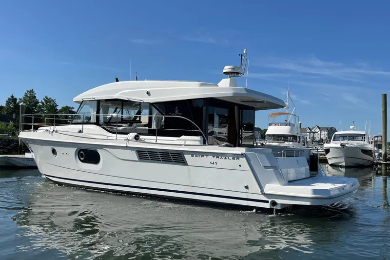  Yacht Photos Pics 2026 Beneteau 41 Swift Trawler Sedan in marina, sleek design, sunny day.