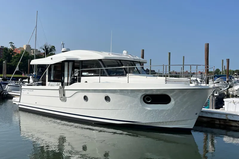  Yacht Photos Pics 2026 Beneteau 41 Swift Trawler Sedan docked at marina under clear blue sky.
