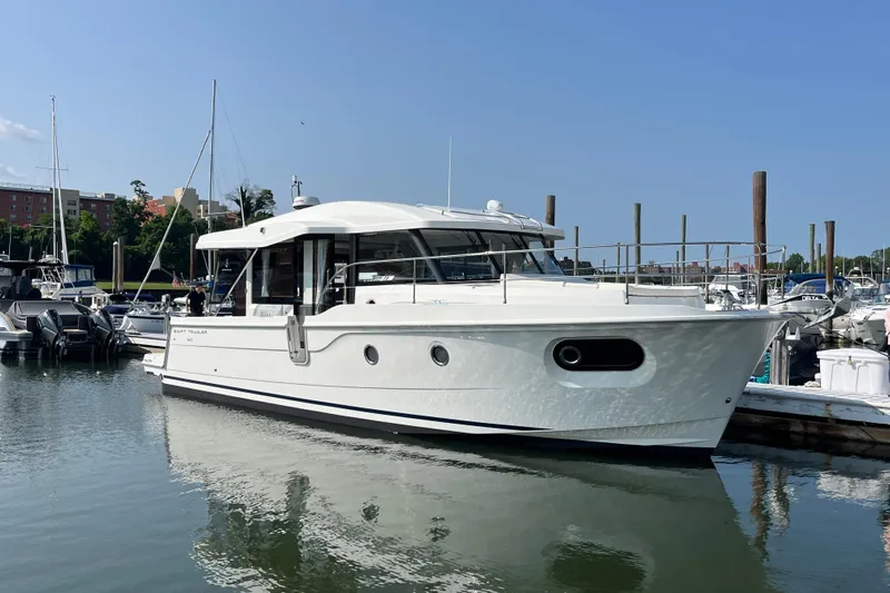  Yacht Photos Pics 2026 Beneteau 41 Swift Trawler Sedan docked in a marina under clear skies.
