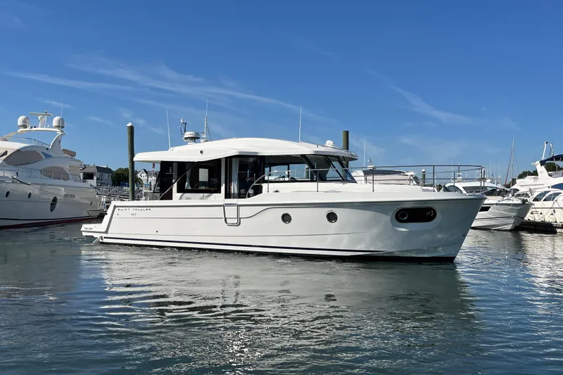  Yacht Photos Pics 2026 Beneteau 41 Swift Trawler Sedan in marina, sleek design, sunny day.