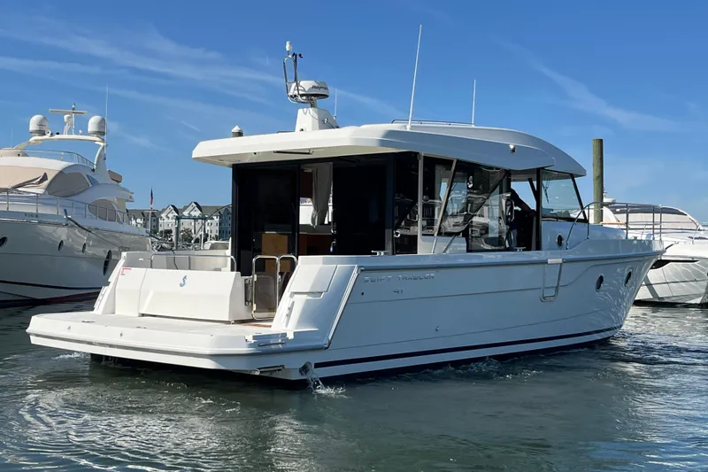  Yacht Photos Pics 2026 Beneteau 41 Swift Trawler Sedan in marina, sleek design, sunny day.