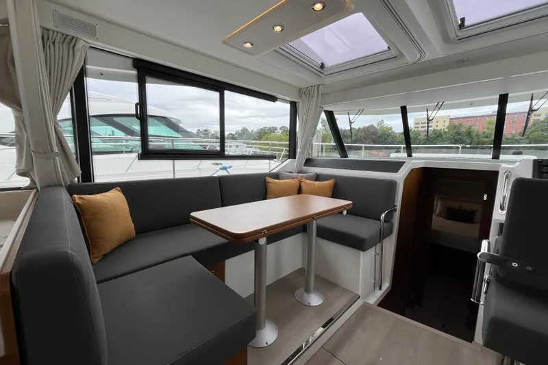  Yacht Photos Pics Luxurious interior of 2026 Beneteau 41 Swift Trawler Sedan with modern seating and table.