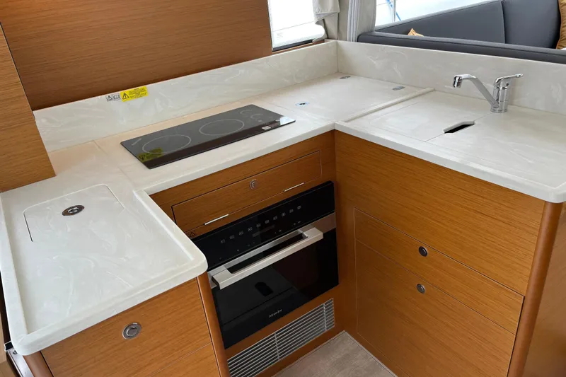  Yacht Photos Pics Modern kitchen in 2026 Beneteau 41 Swift Trawler Sedan with stove, sink, and oven.