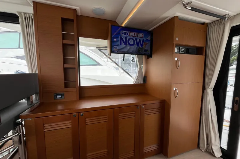  Yacht Photos Pics Interior of 2026 Beneteau 41 Swift Trawler Sedan with TV and wooden cabinetry.