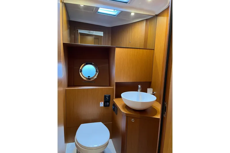  Yacht Photos Pics 2026 Beneteau 41 Swift Trawler Sedan bathroom with modern fixtures and wood finish.