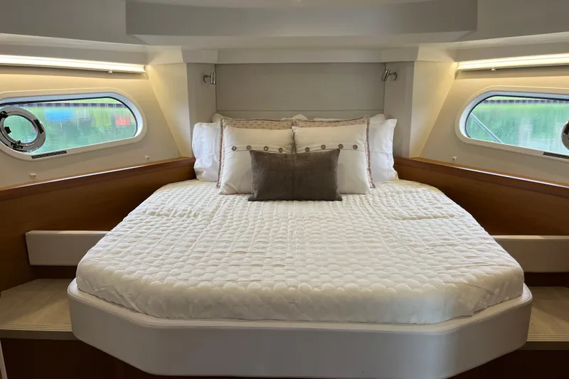  Yacht Photos Pics Luxurious bedroom interior of 2026 Beneteau 41 Swift Trawler Sedan with elegant bedding.