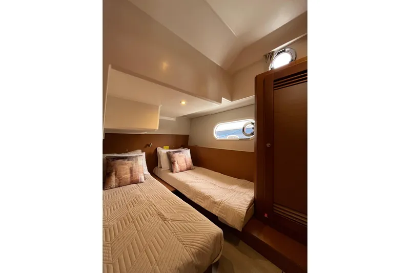  Yacht Photos Pics Interior of 2026 Beneteau 41 Swift Trawler Sedan with twin beds and porthole.