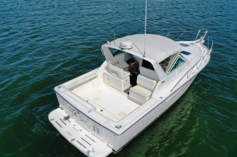  Yacht Photos Pics 2001 Tiara 31 Open boat on calm water, featuring spacious deck and sleek design.