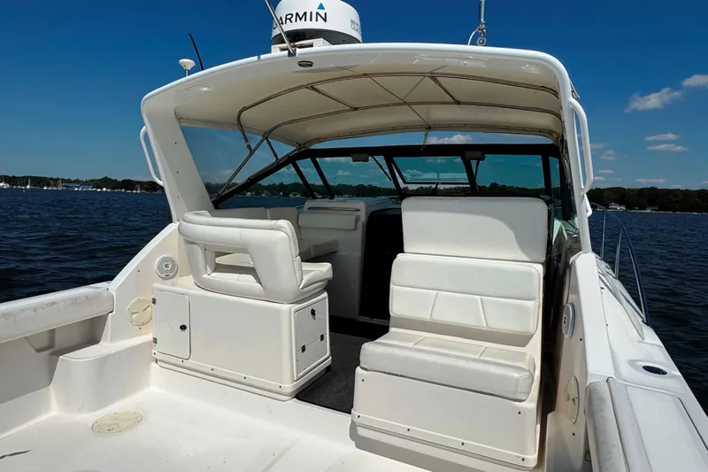  Yacht Photos Pics 2001 Tiara 31 Open boat with white seating, cruising on a sunny day.