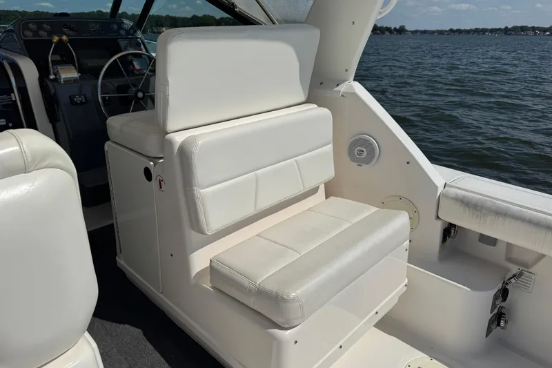  Yacht Photos Pics 2001 Tiara 31 Open boat interior with white seating and steering wheel, on a lake.