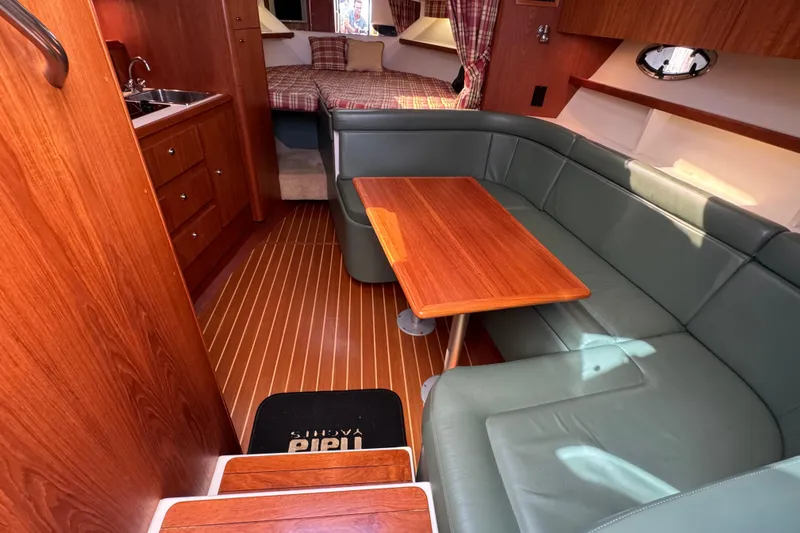  Yacht Photos Pics Interior of 2001 Tiara 31 Open yacht with wood finishes and cozy seating area.