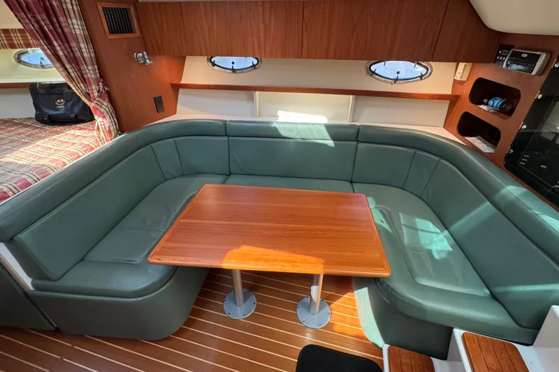  Yacht Photos Pics 2001 Tiara 31 Open yacht interior with green seating and wooden table.
