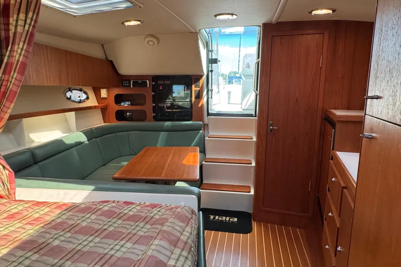  Yacht Photos Pics Interior of 2001 Tiara 31 Open yacht with wood finishes and cozy seating area.
