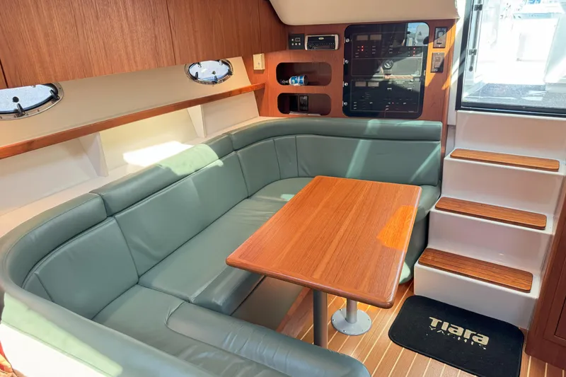  Yacht Photos Pics Interior of 2001 Tiara 3100 Open yacht with cozy seating and wooden table.
