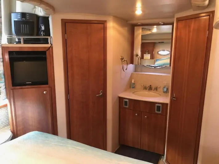 Good Times Yacht Photos Pics Interior of 2004 Meridian 459 Motoryacht with wood cabinetry and compact bathroom.