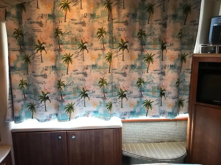 Good Times Yacht Photos Pics Interior of 2004 Meridian 459 Motoryacht with tropical-themed curtains and wooden cabinetry.
