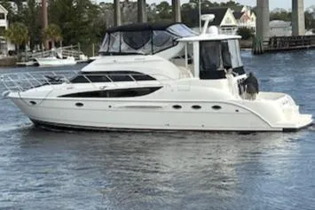 Good Times Yacht Photos Pics 2004 Meridian 459 Motoryacht cruising on a calm river with scenic background.