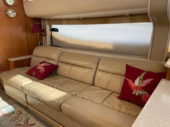 Good Times Yacht Photos Pics Luxurious interior of 2004 Meridian 459 Motoryacht with beige leather sofa and decorative pillows.
