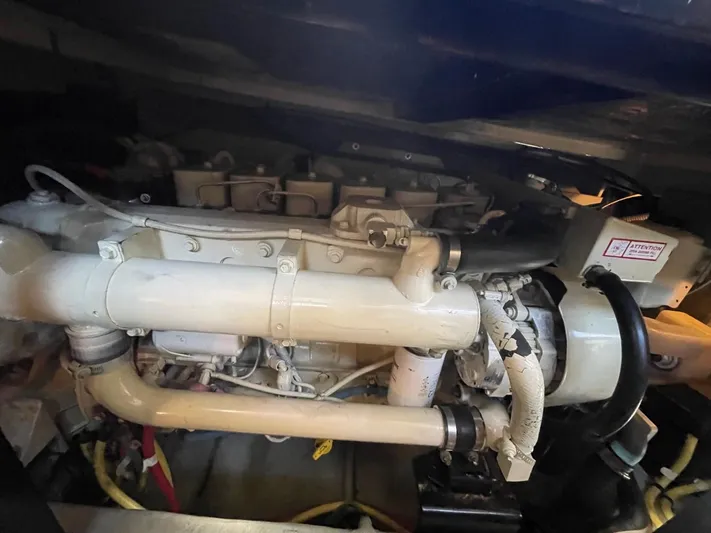 Good Times Yacht Photos Pics Engine compartment of a 2004 Meridian 459 Motoryacht, showcasing mechanical components and piping.