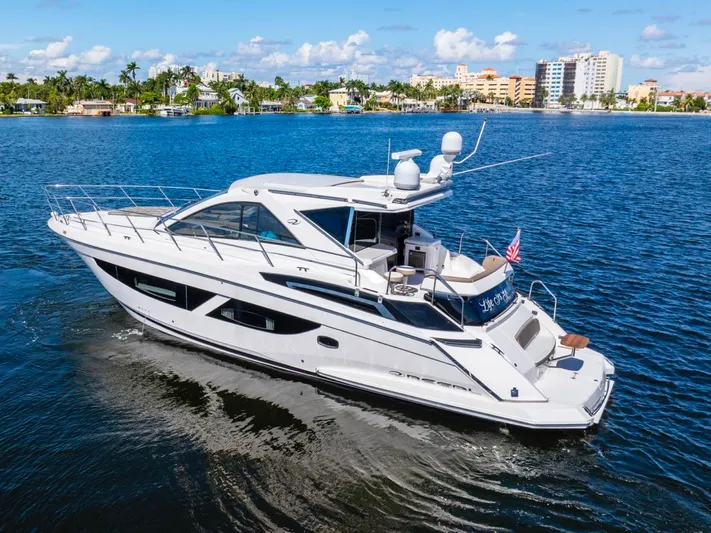  Yacht Photos Pics 2017 Regal 53 Sport Coupe yacht cruising on a sunny day in a coastal city.