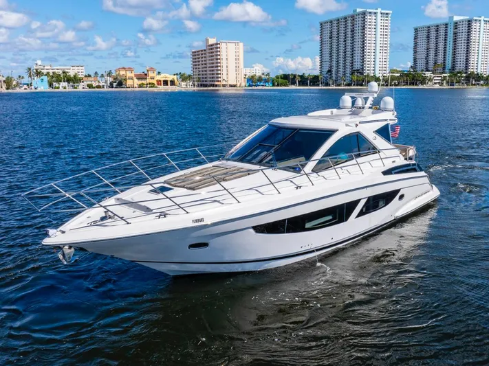  Yacht Photos Pics 2017 Regal 53 Sport Coupe yacht cruising on a sunny day with cityscape background.