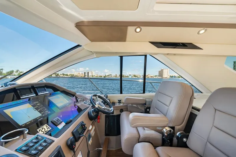  Yacht Photos Pics Luxurious interior of 2017 Regal 53 Sport Coupe yacht with modern helm and panoramic windows.