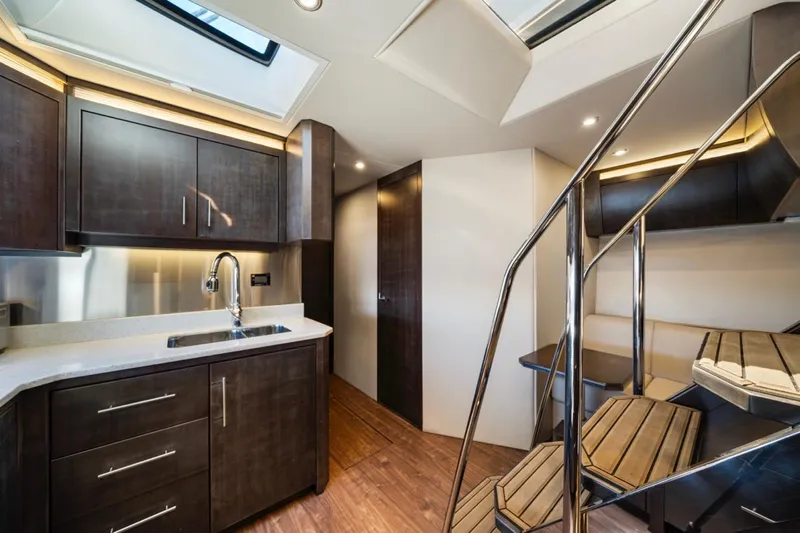  Yacht Photos Pics Luxurious interior of 2017 Regal 53 Sport Coupe yacht with modern kitchen and sleek staircase.