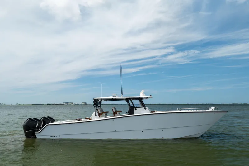  Yacht Photos Pics 2025 Freeman 42 LR boat on calm water under a partly cloudy sky.