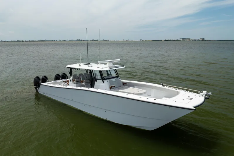  Yacht Photos Pics 2025 Freeman 42 LR boat on calm water, showcasing sleek design and powerful engines.