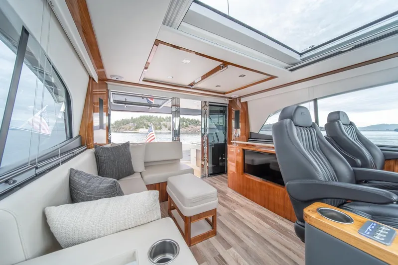  Yacht Photos Pics Luxurious interior of 2021 Riviera 64 Sports Motor Yacht with plush seating and scenic views.